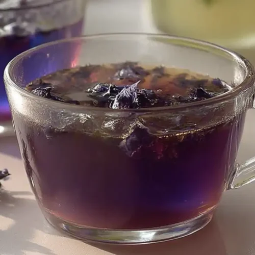 brazilian mounjaro recipe in a glass cup with butterfly pea flowers
