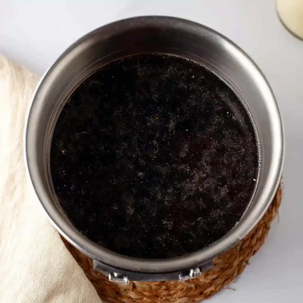 Dark piloncillo syrup simmering in stainless pot