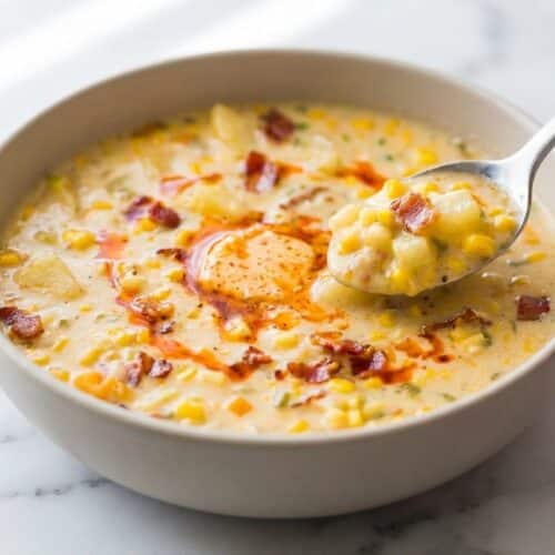 Creamy corn chowder recipe in a rustic bowl, garnished with green onions and a swirl of melted Smoked Paprika & Miso Finishing Butter.