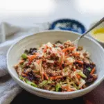 Hearty egg roll in a bowl with savory ground pork and finely chopped shiitake mushrooms, garnished with toasted sesame seeds and a drizzle of sesame oil.