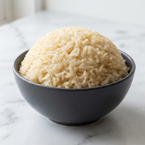 Fluffy Instant Pot Jasmine Rice toasted in sesame oil for an aromatic, nutty finish in a white bowl.