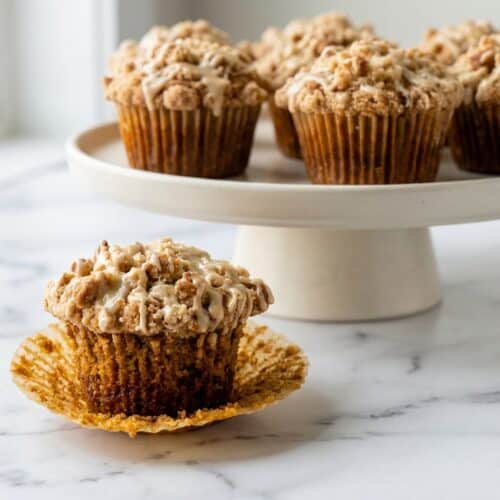Pumpkin Cinnamon Roll Muffins with a brown butter infused streusel topping and sweet maple glaze drizzle.