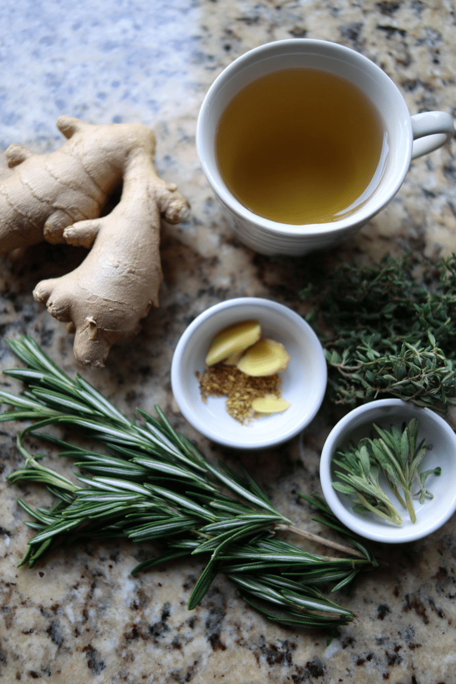 A flat lay of raw ingredients for a tart cherry mocktail for better sleep, showing tart cherry juice, fresh ginger, chamomile tea, and cinnamon sticks.