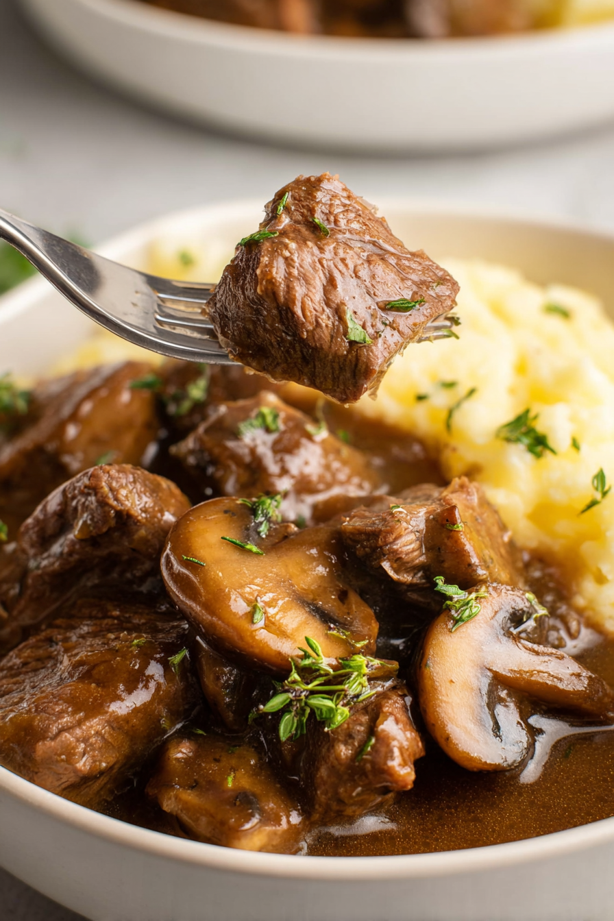 Macro close-up of tender beef tips crock pot recipes, showcasing the succulent texture of the slow-cooked meat and rich gravy.