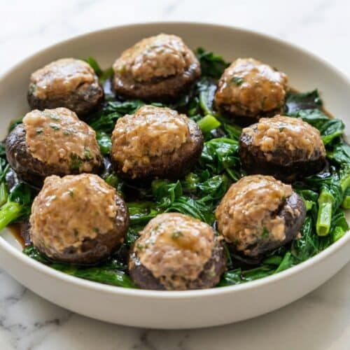 Glazed Asian stuffed mushrooms recipe featuring savory ground pork with crunchy water chestnuts and white pepper.