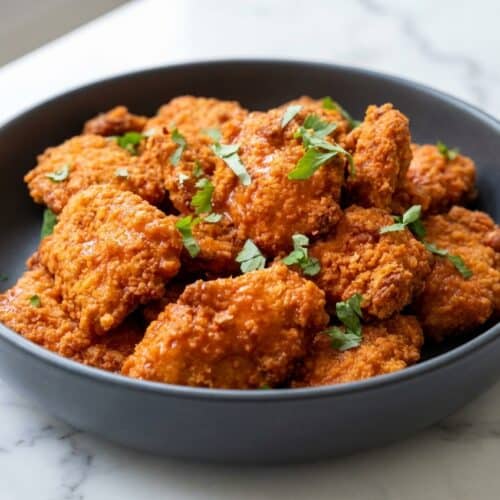 Crispy baked boneless buffalo wings with a cornstarch-dredged coating and spicy red glaze.
