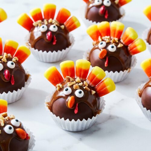 Turkey oreo balls with a bourbon-maple infusion, candy corn feathers, and a smooth chocolate coating.