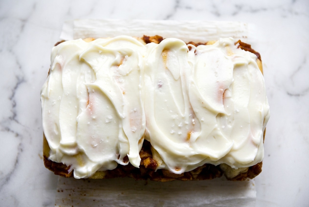 Silky cream cheese glaze with brown butter notes and sea salt drizzled over a fresh bundt cake.