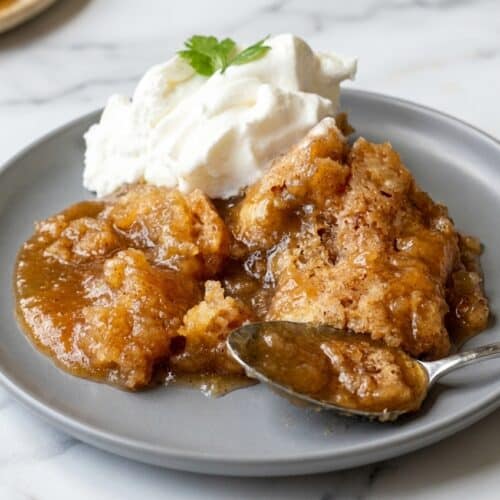 Warm snickerdoodle cobbler in a baking dish with a nutty browned butter crust and cinnamon sugar topping.