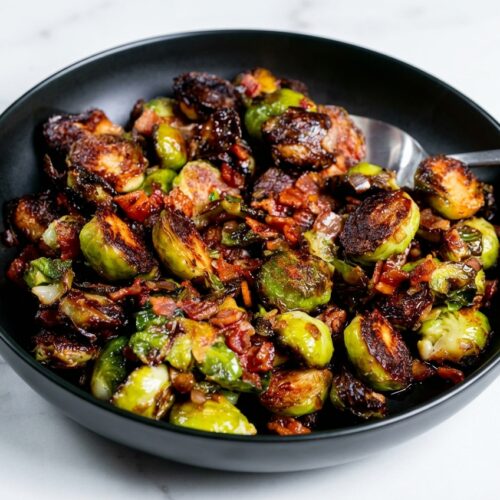 Pan-seared brussels sprouts with bacon, glazed with apple cider vinegar and a pinch of smoked paprika.