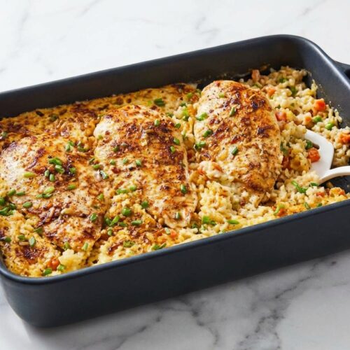 Golden butter-seared no peek chicken and rice in a baking dish showing the Maillard boost effect.