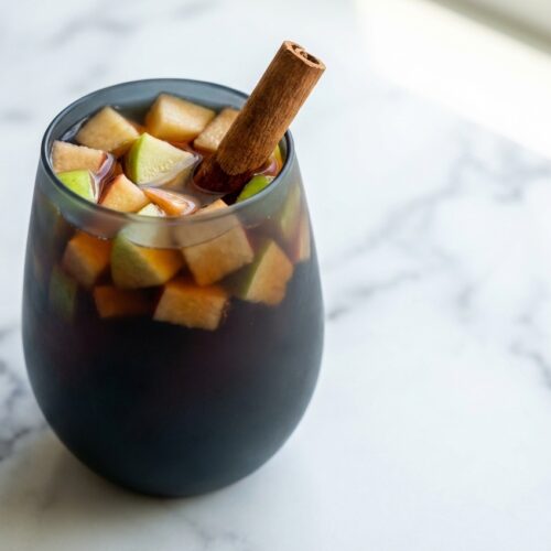 A pitcher of family friendly sangria with citrus slices, using decaf black tea for a sophisticated tannin boost.
