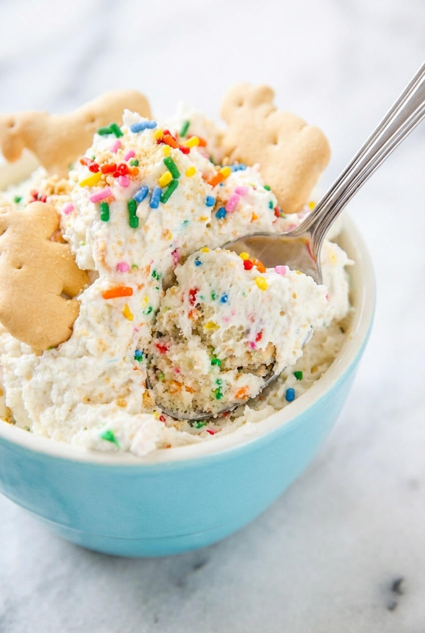 Close-up of the fluffy Funfetti Dip texture highlighting the safety of heat-treated flour and airy whipped topping.