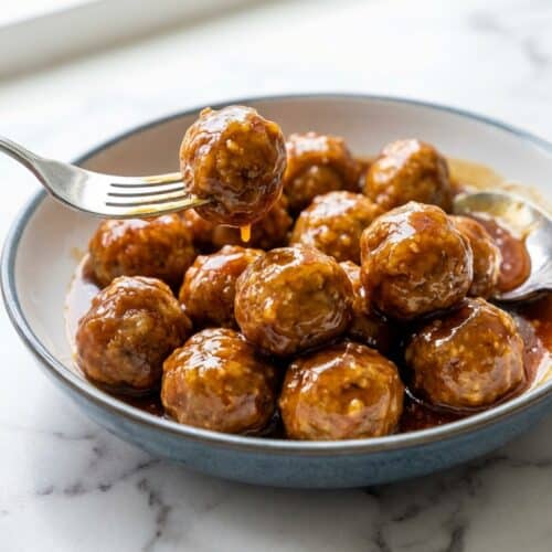 Glazed Honey Garlic Meatballs with a tangy apple cider vinegar and toasted sesame oil sauce in a bowl.