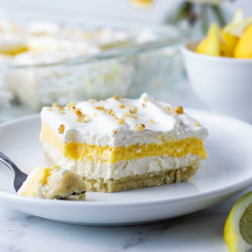 Layered keto lemon lush dessert featuring a toasted brown butter pecan shortbread crust and creamy lemon filling.