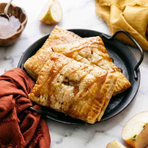 Golden caramel apple puff pastries with cardamom spice and a glossy miso-salted caramel drizzle.