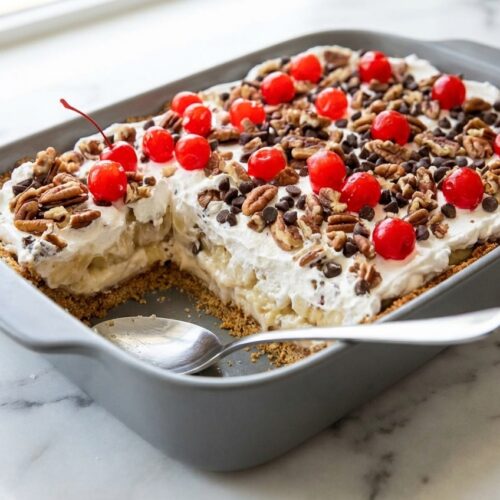 Layered no bake banana split dessert with a brown butter and sea salt graham cracker crust and whipped topping.