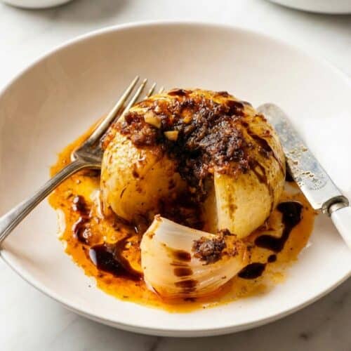 Savory onion boil recipe featuring tender Vidalia onions with an umami-balsamic depth charge glaze.