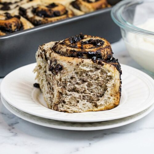 Oreo stuffed cinnamon rolls drizzled with cream cheese icing and filled with a dark black cocoa brown butter swirl.