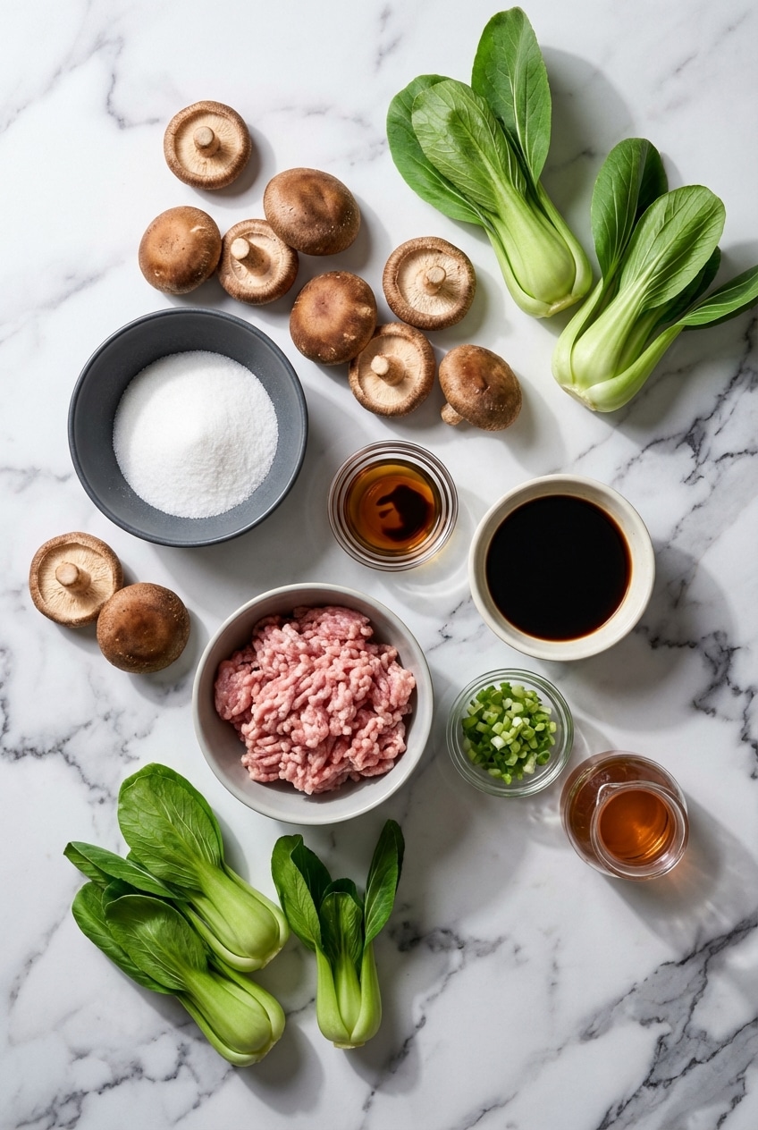 Flat lay of Asian stuffed mushrooms recipe ingredients including shiitake mushrooms, ground pork, and Shaoxing wine.