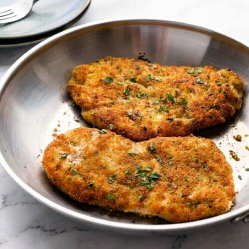 Golden brown parmesan crusted chicken featuring a zesty double-citrus pecorino crust and fresh herbs.