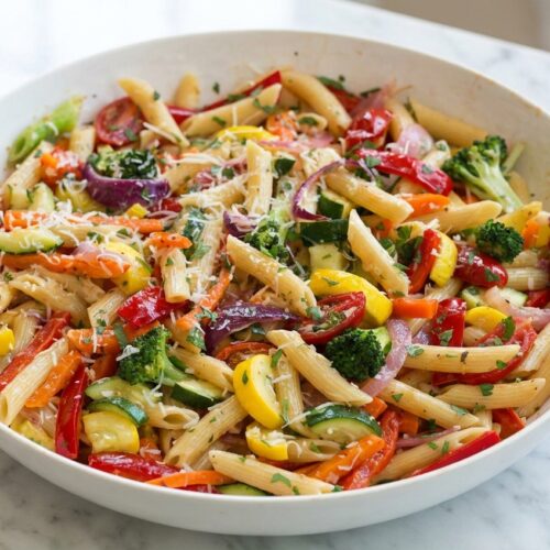 Pasta primavera with julienne vegetables tossed in golden brown butter and red pepper infused oil.