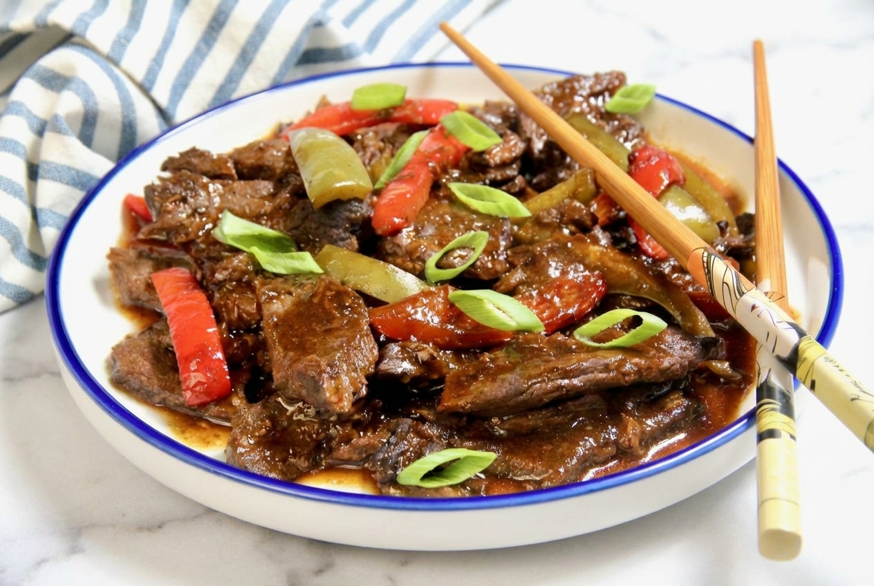 Tender velveted pepper steak recipe with colorful bell peppers and a glossy ginger-honey glaze.