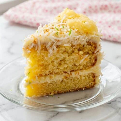 Pineapple coconut dream cake featuring browned coconut butter and a lime zest cream cheese frosting.