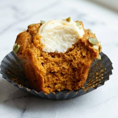 Golden pumpkin cream cheese muffins with a browned butter crumb and fragrant cardamom spice.
