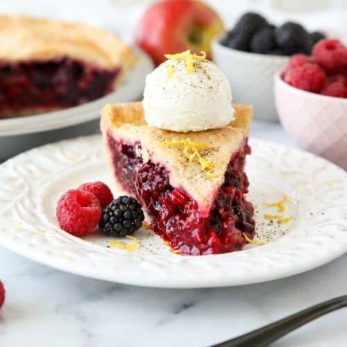Golden razzleberry pie with a flaky lattice crust and subtle cardamom-lemon zest sugar finish.