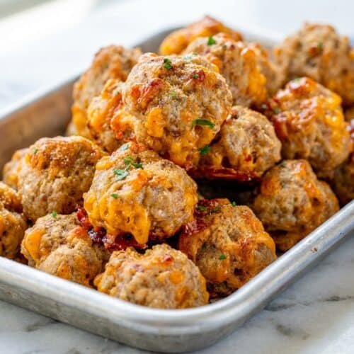 Golden cream cheese sausage balls seasoned with savory Worcestershire sauce and garlic powder on a serving platter.