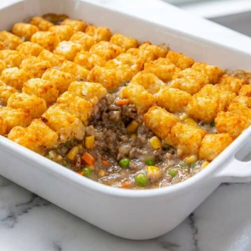 Golden tater tot casserole with ground beef featuring a rich, umami-boosted beef layer and melted cheddar cheese.