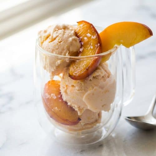 Creamy peach frozen yogurt topped with bourbon-infused roasted peach slices and a pinch of flaky sea salt.