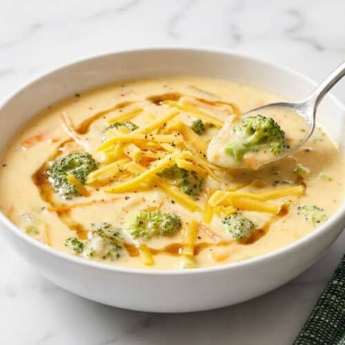 Creamy broccoli cheddar soup in a bowl, showing a rich texture from a nutty brown butter roux and sharp dijon.