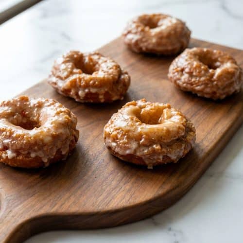 Glazed old fashioned sour cream donuts with brown butter, showing craggy edges and a golden-brown finish.