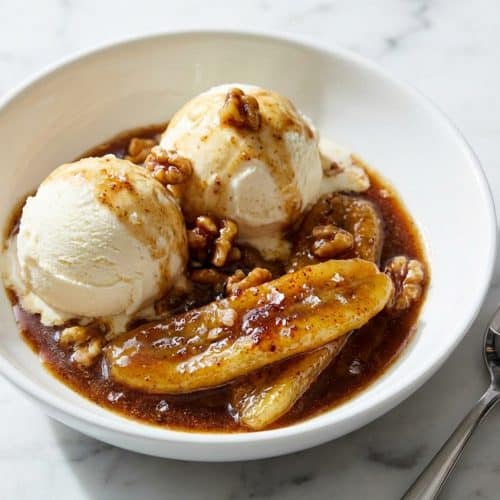 Sizzling bananas foster with a brown butter sea salt glaze served over melting vanilla ice cream.