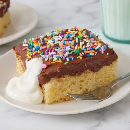 Moist yellow cake slice made with nutty brown butter and tangy sour cream on a dessert plate.