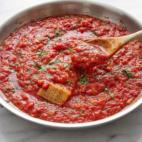 Glossy marinara sauce finished with a silky butter emulsification and a savory Parmesan rind infusion.