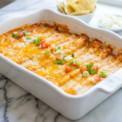 Bubbly Cheese Enchiladas in red sauce featuring a zesty pickled jalapeño and brine-infused cheese filling.
