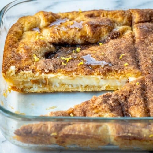 Golden cheesecake crescent rolls topped with nutty browned butter and fresh lemon zest.