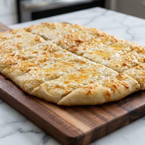 Cheesy garlic breadsticks brushed with sweet honey and smoky paprika garlic butter for a unique flavor profile.
