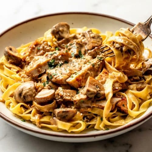 Creamy chicken marsala pasta finished with a cold butter mount and sherry for a glossy, velvet-textured sauce.