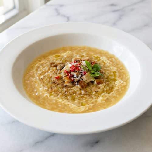 Bowl of Chicken Pastina Soup with a silky egg-parmesan temper and fresh herbs.