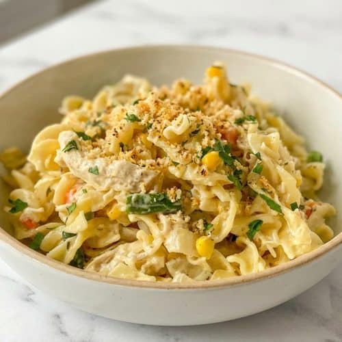 Creamy chicken pot pie pasta recipe served in a bowl, generously topped with toasted buttery herb-panko breadcrumbs.