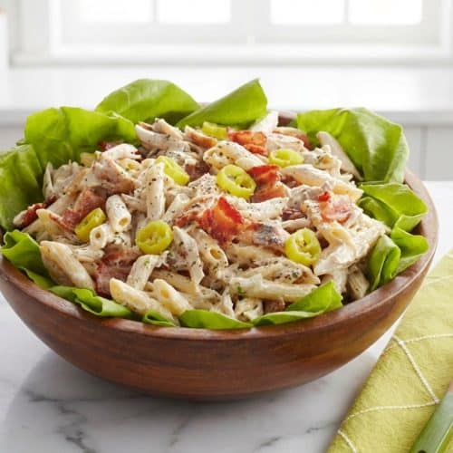 Creamy chicken ranch pasta salad with crispy bacon and rotini, brightened by a secret splash of pepperoncini brine.