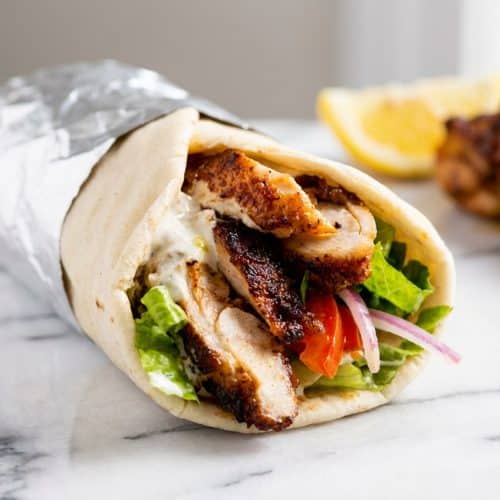 Golden brown chicken shawarma recipe piled high highlighting crispy edges from the post-slice sear technique