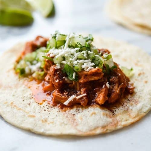 Shredded Chicken Tinga Tacos with a deep mahogany sauce using the dark cocoa depth hack for savory complexity.