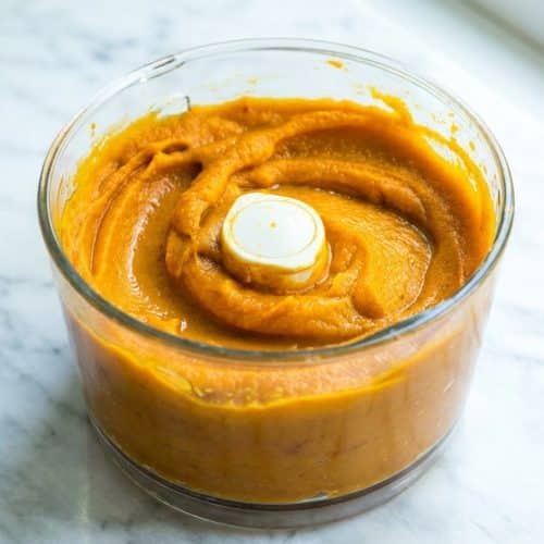 Smooth, deep orange pumpkin puree made using the concentration roast method in a glass bowl.