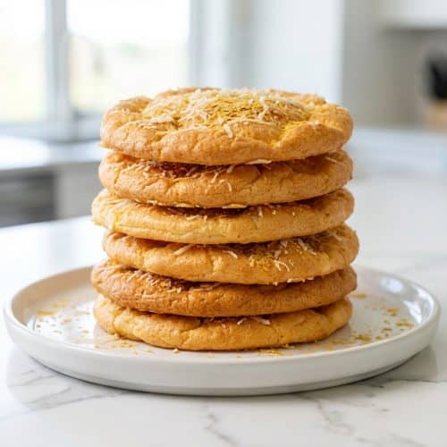 Golden Cottage Cheese Cloud Bread infused with savory Parmesan and nutritional yeast on a cooling rack.