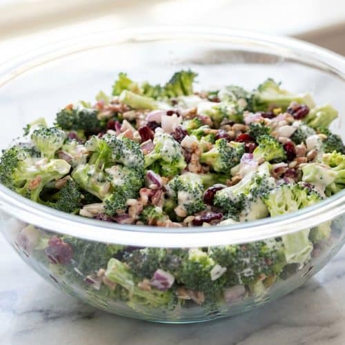 Creamy broccoli salad featuring a savory white miso dressing, crisp florets, and smoky bacon bits.